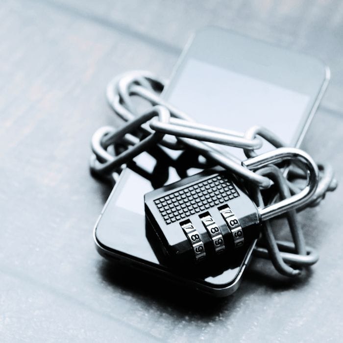 How To Know If My Husband Is Cheating: 15 Signs That Can’t Be Ignored 2 Phone in chains with a padlock, symbolizing how a cheating husband hides his phone from wife